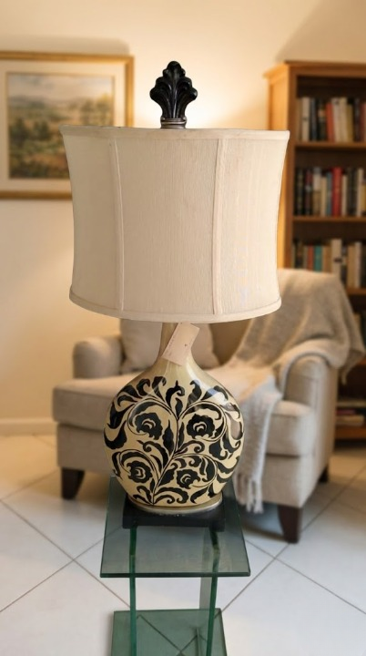 Arlumina black floral ginger jar lamp with vine motifs on a wooden side table in a modern living room.